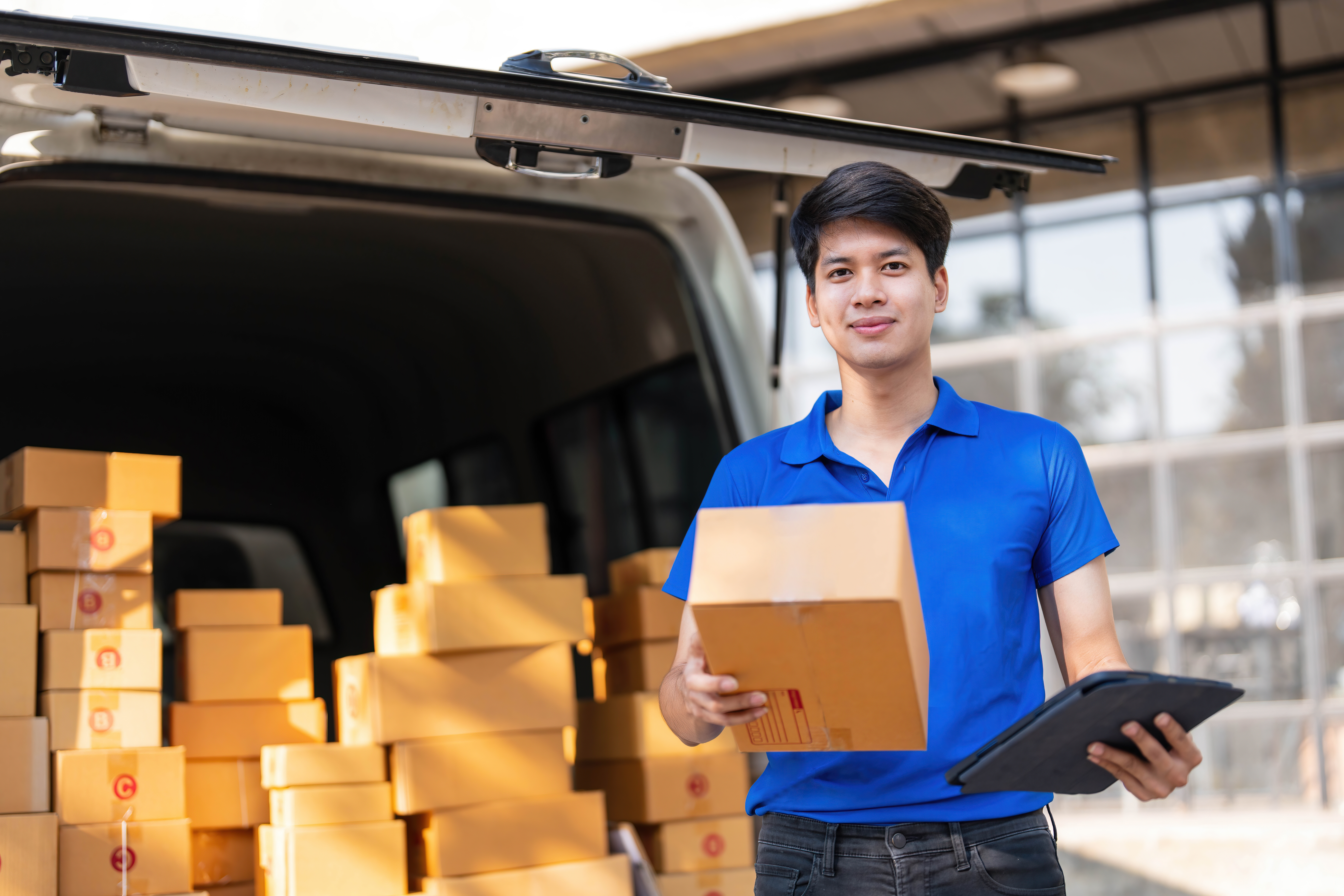 Asian courier with parcel and delivery logistic concept. Delivery man with checking list on